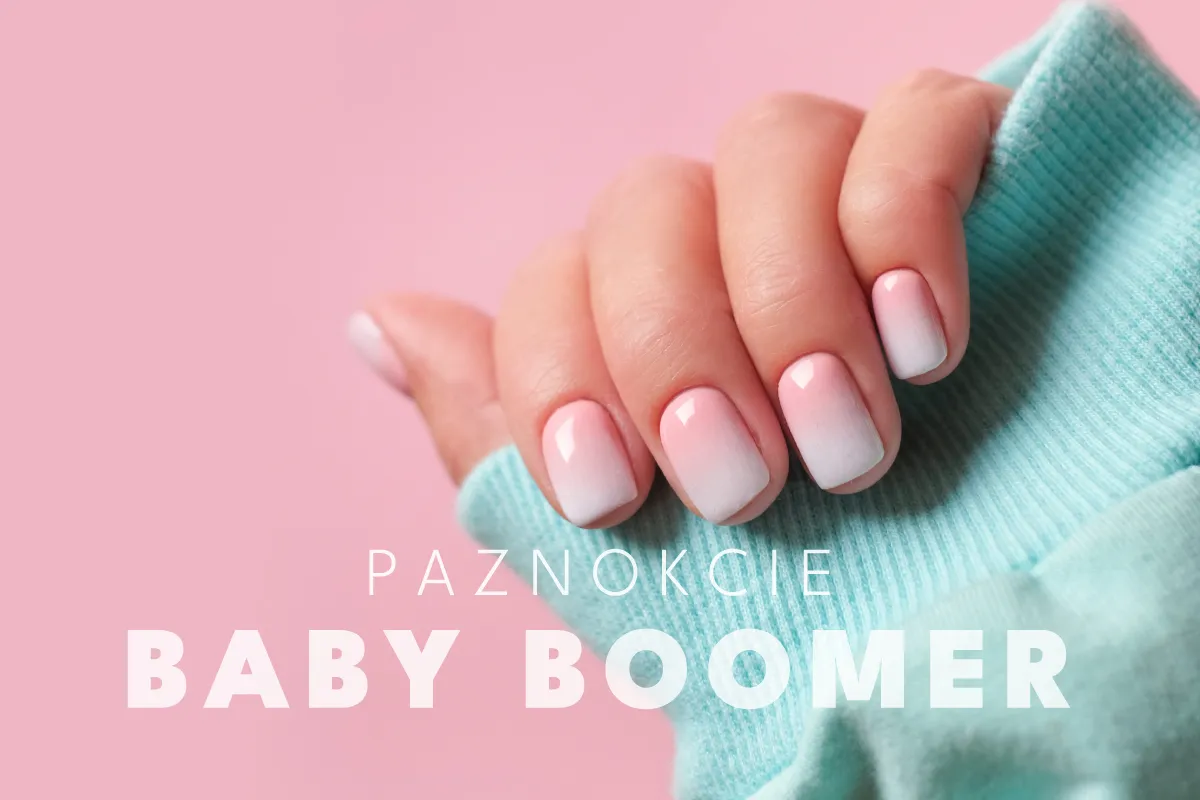 Dłoń z paznokciami hybrydowymi baby boomer w delikatnym różowo-białym ombre.