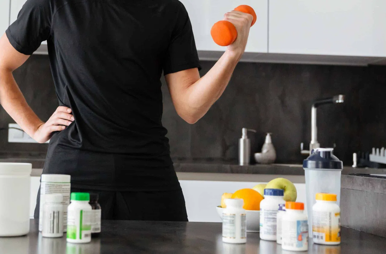 Sportowiec w akcji z suplementami na tle