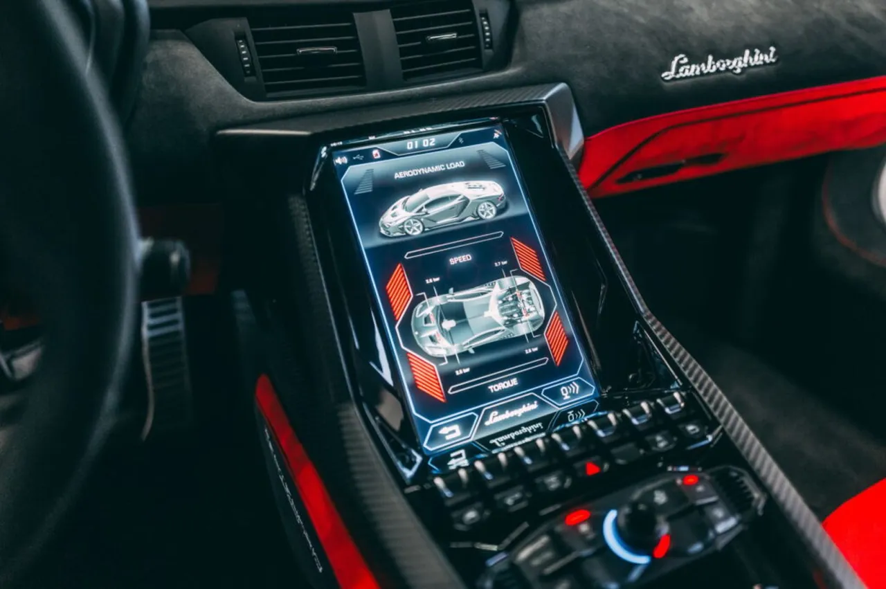 Wnętrze Lamborghini Centenario z ekranem pokazującym dane aerodynamiczne, prędkość i moment obrotowy. Zastanawiasz się, ile kosztuje Lamborghini Centenario?