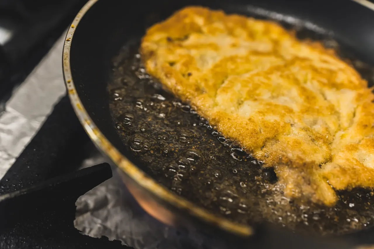 Schabowy smażony na smalcu, a na oleju roślinnym. Złocisty kotlet bulgocze w gorącym tłuszczu.