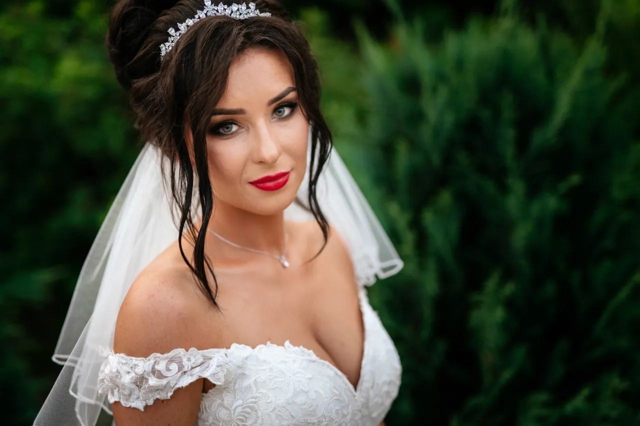 Panna młoda w koronkowej sukni z gładkim welonem