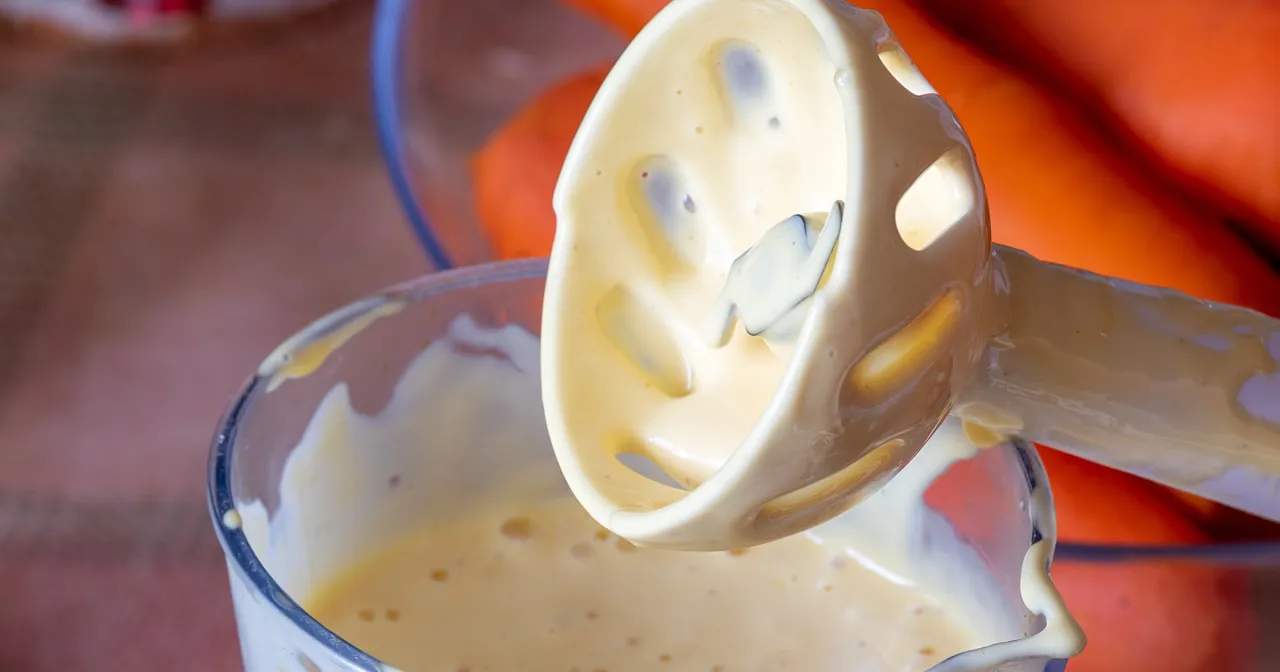 Domowy majonez dietetyczny powstaje w mikserze. W tle marchewki.