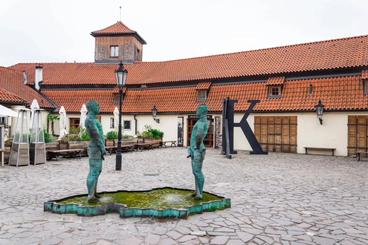 Dwie rzeźby sikających mężczyzn przed Muzeum Sztuki Wsp&oacute;łczesnej Praga.